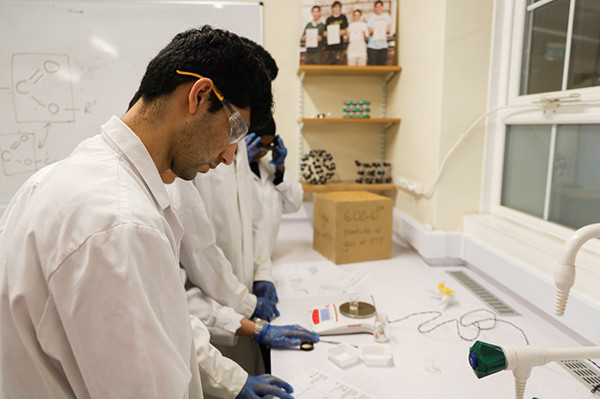 ESOL student Mohamed prepares the benzoic acid by weighing out the required quantity.