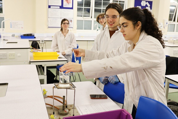 A1 students Justin and Hastie heat the mixture in the pre-prepared pipette using a water bath.